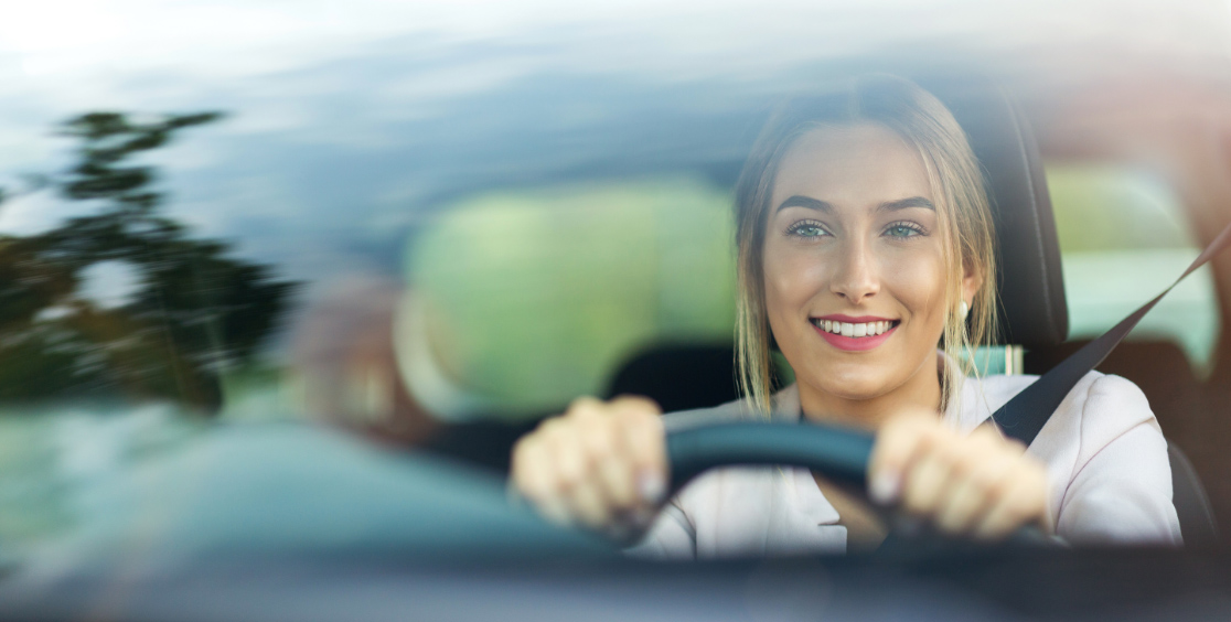 Woman driving and looking through windshield
